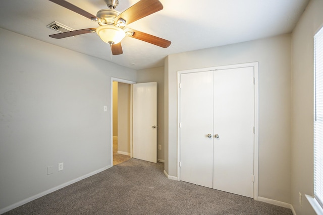 unfurnished bedroom featuring carpet flooring, ceiling fan, and a closet