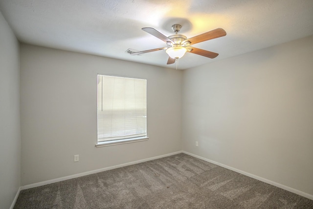 spare room featuring ceiling fan and carpet floors