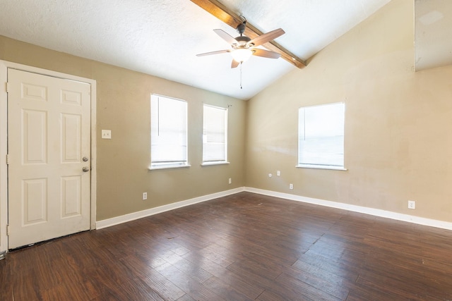 empty room featuring dark hardwood / wood-style flooring, a textured ceiling, lofted ceiling with beams, and ceiling fan