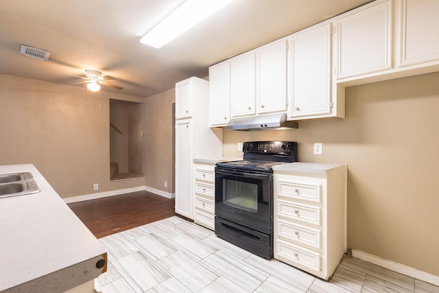 kitchen featuring sink, electric range, white cabinets, and ceiling fan