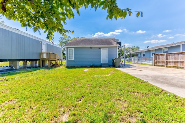 back of house with a yard and a patio area