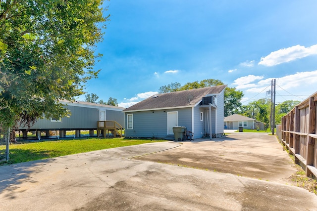 view of side of home with a lawn