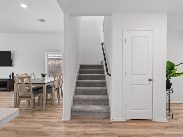 staircase featuring wood-type flooring