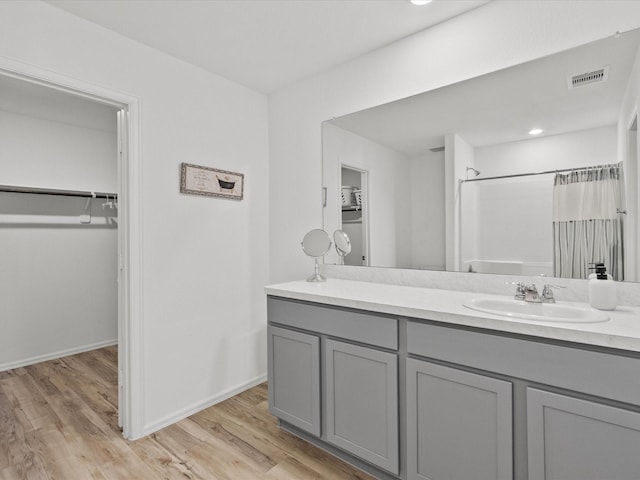 bathroom featuring vanity, wood-type flooring, and curtained shower