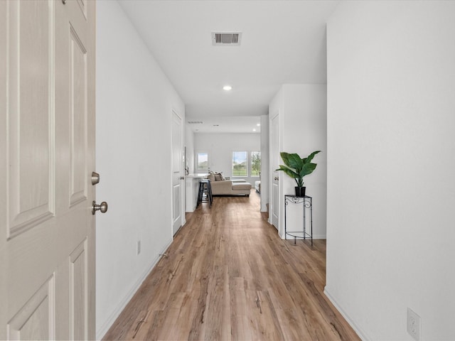 hall with light hardwood / wood-style flooring