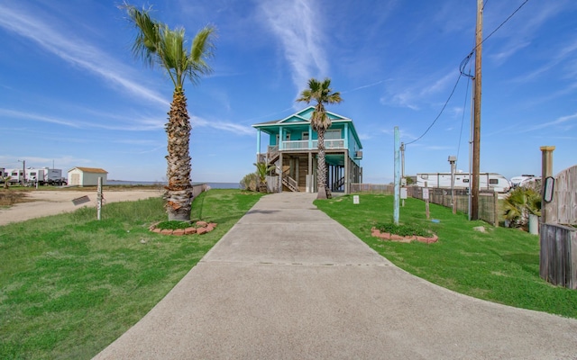 raised beach house with a carport and a front yard