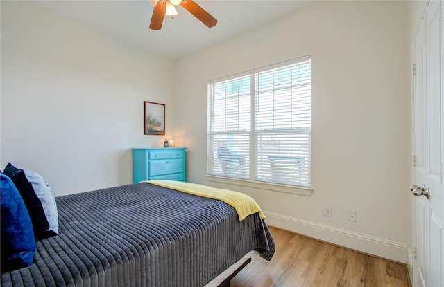 bedroom with ceiling fan and light wood-type flooring