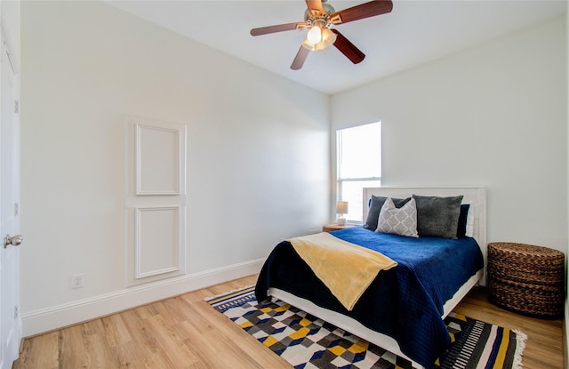 bedroom featuring hardwood / wood-style floors and ceiling fan