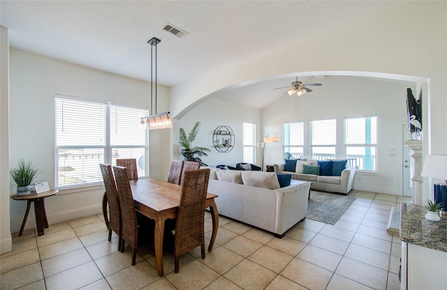 dining space with plenty of natural light, vaulted ceiling, and light tile patterned floors