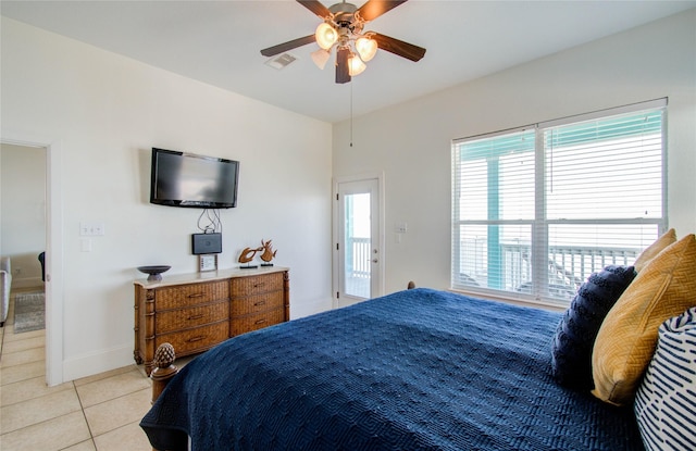 tiled bedroom featuring ceiling fan