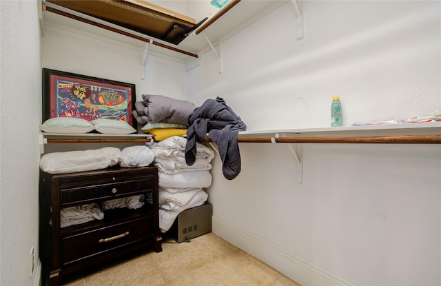 walk in closet featuring light tile patterned flooring