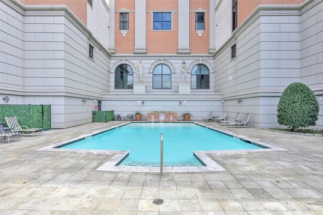 view of swimming pool featuring a patio area