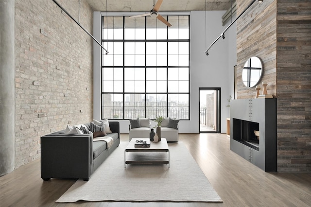 living room featuring a healthy amount of sunlight, hardwood / wood-style floors, and ceiling fan