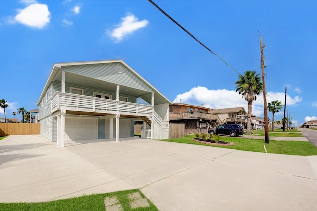 view of front facade featuring a garage, a balcony, and a front lawn