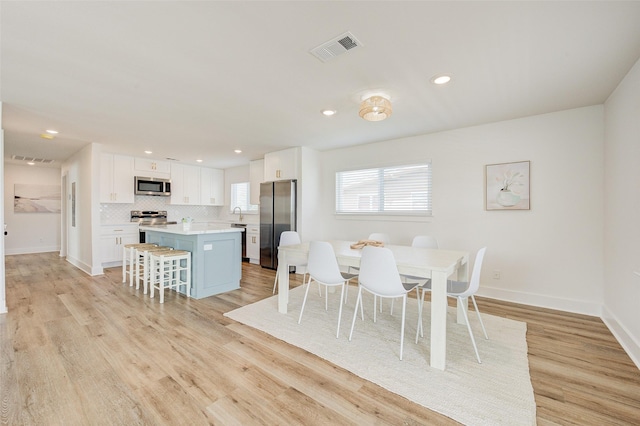 dining area with light hardwood / wood-style flooring