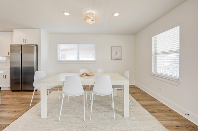 dining area with light hardwood / wood-style floors