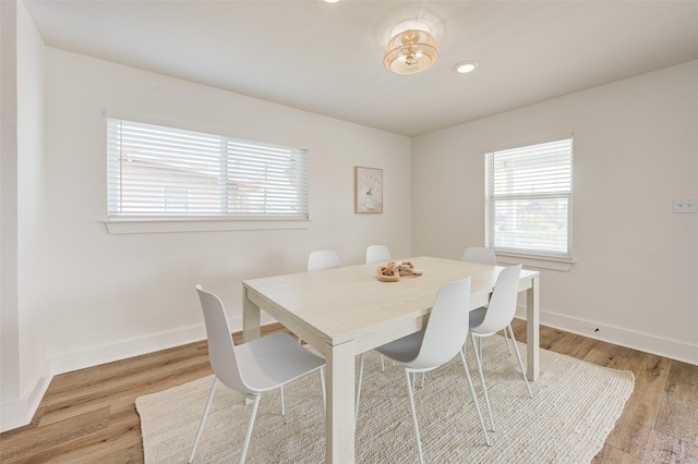 dining space with light hardwood / wood-style flooring