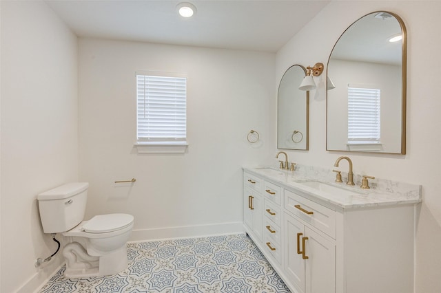 bathroom featuring vanity, tile patterned floors, and toilet