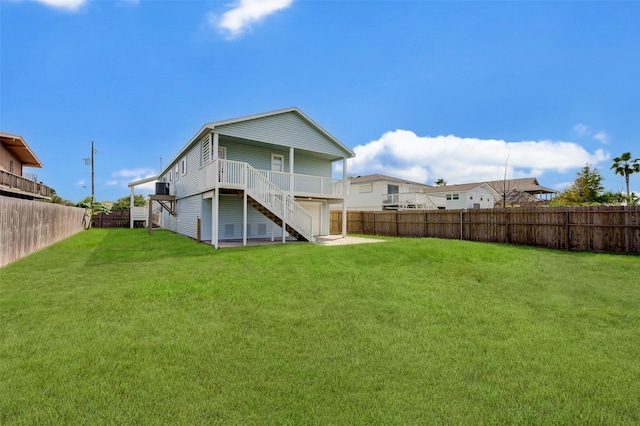 rear view of property featuring a yard