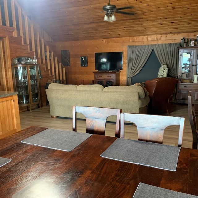 living room featuring wood ceiling, vaulted ceiling, wooden walls, hardwood / wood-style flooring, and ceiling fan