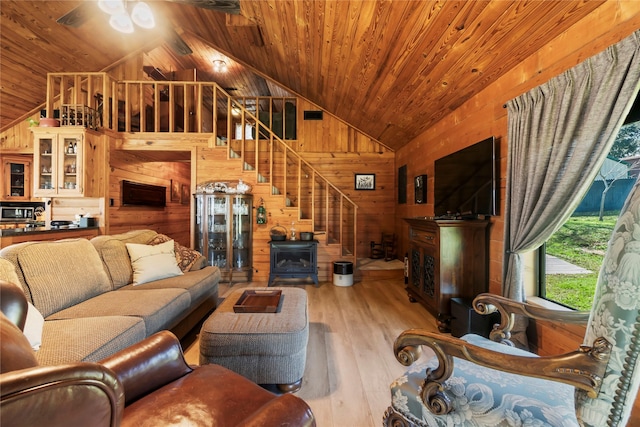 586 Beverly Blvd, Onalaska, TX 77360 - living area with lofted ceiling, wood walls, wood-type flooring, stairway, and wood ceiling