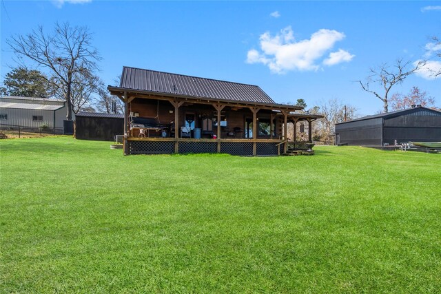 586 Beverly Blvd, Onalaska, TX 77360 - back of house featuring a lawn and metal roof