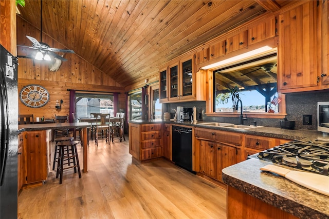 kitchen featuring plenty of natural light, sink, wood ceiling, and black appliances