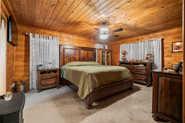 bedroom with wood walls, ceiling fan, light carpet, and wooden ceiling