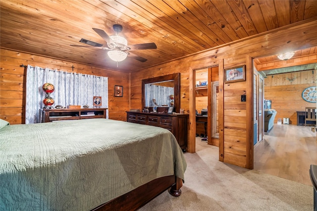 bedroom featuring light carpet, ceiling fan, wooden walls, and wood ceiling