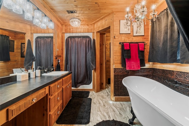 bathroom featuring wooden ceiling, a chandelier, a washtub, and wooden walls