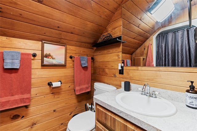 bathroom featuring lofted ceiling, vanity, wood walls, toilet, and wood ceiling