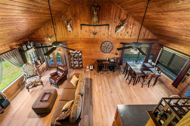 living room featuring hardwood / wood-style floors, high vaulted ceiling, wooden walls, and wood ceiling