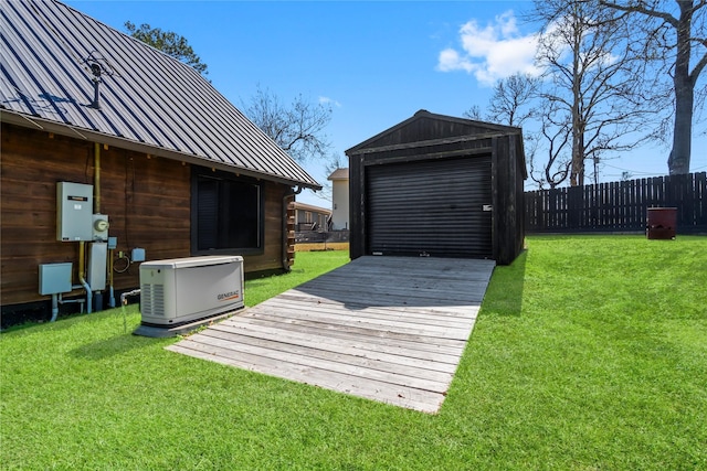 wooden deck with an outbuilding, a garage, and a lawn