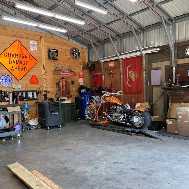 586 Beverly Blvd, Onalaska, TX 77360 - garage featuring wood walls and metal wall