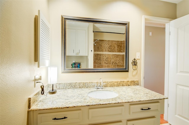 bathroom featuring vanity and a shower