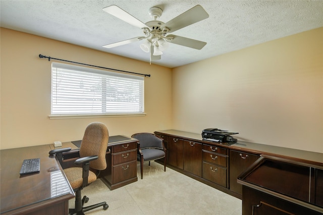 office area with ceiling fan, light carpet, and a textured ceiling