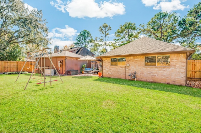 view of yard with a playground and a patio