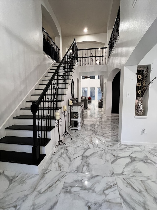 entryway featuring a towering ceiling