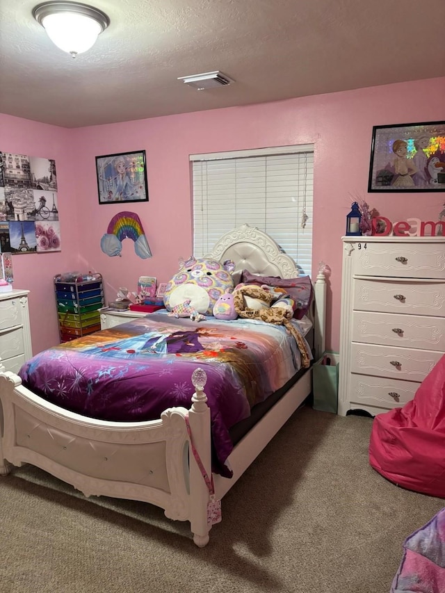 carpeted bedroom featuring a textured ceiling