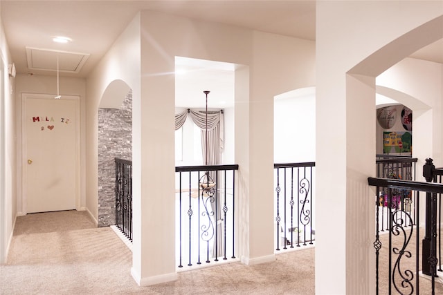 10722 Trail Ridge Dr, Houston, TX 77064 - hallway featuring carpet floors, attic access, and arched walkways