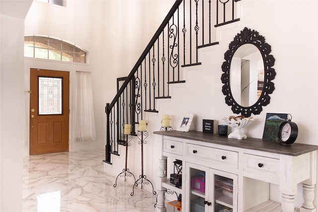 10722 Trail Ridge Dr, Houston, TX 77064 - entryway with light marble finish floors, stairway, and a towering ceiling