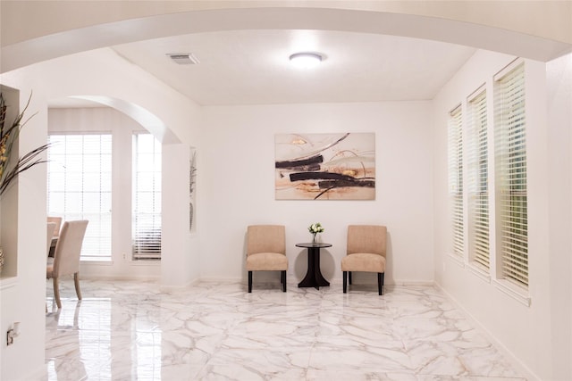 10722 Trail Ridge Dr, Houston, TX 77064 - sitting room with marble tiled flooring, arched walkways, and baseboards