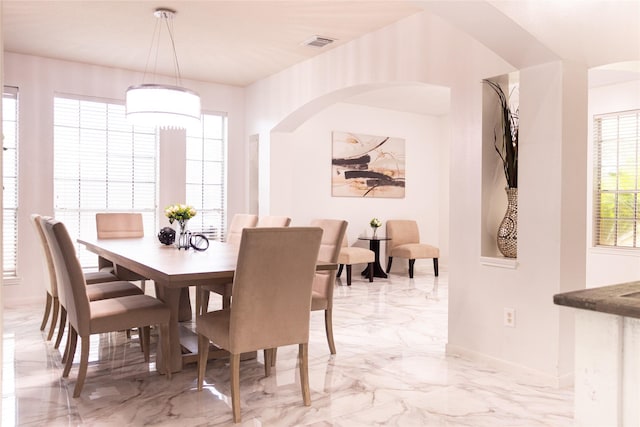 10722 Trail Ridge Dr, Houston, TX 77064 - dining room with light marble finish flooring, baseboards, and arched walkways
