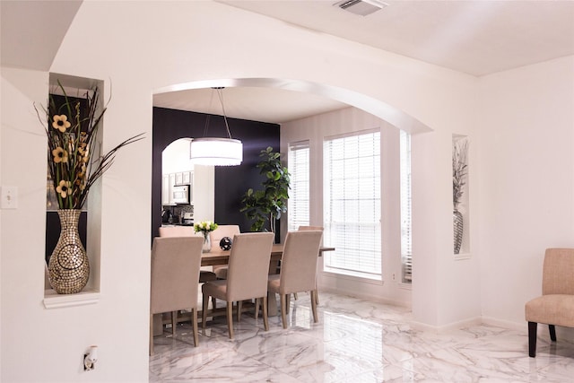 10722 Trail Ridge Dr, Houston, TX 77064 - dining area with plenty of natural light, arched walkways, and marble finish flooring