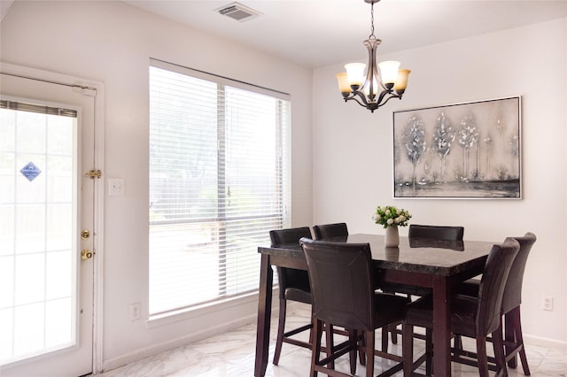10722 Trail Ridge Dr, Houston, TX 77064 - dining room featuring light marble finish flooring, a chandelier, baseboards, and plenty of natural light