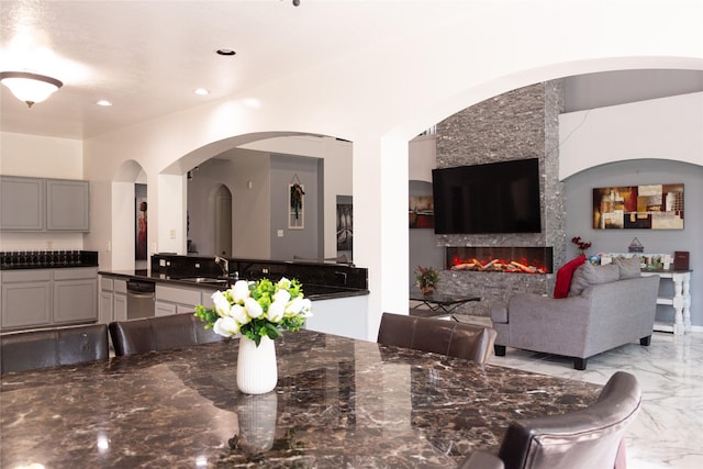 10722 Trail Ridge Dr, Houston, TX 77064 - dining room featuring light marble finish flooring, a fireplace, and recessed lighting