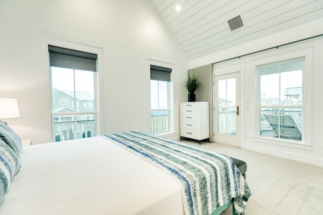 carpeted bedroom featuring vaulted ceiling and access to exterior