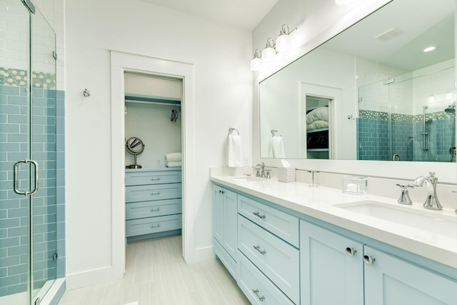 bathroom with vanity and a shower with shower door