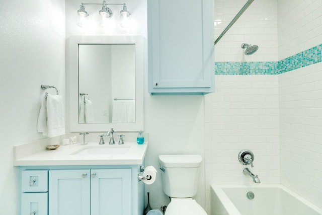 full bathroom with vanity, tiled shower / bath combo, and toilet