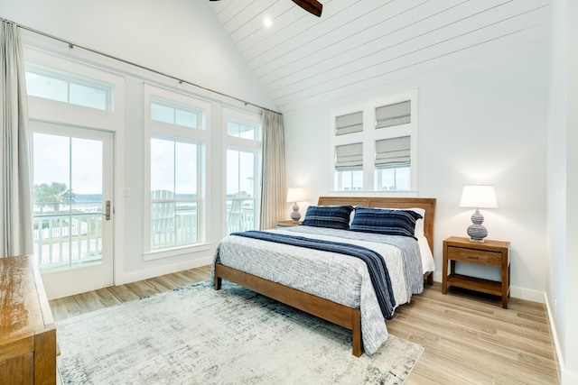 bedroom with ceiling fan, lofted ceiling, light hardwood / wood-style flooring, and access to outside